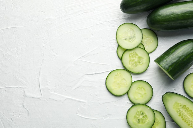 Fresh green cucumbers on white background, top view