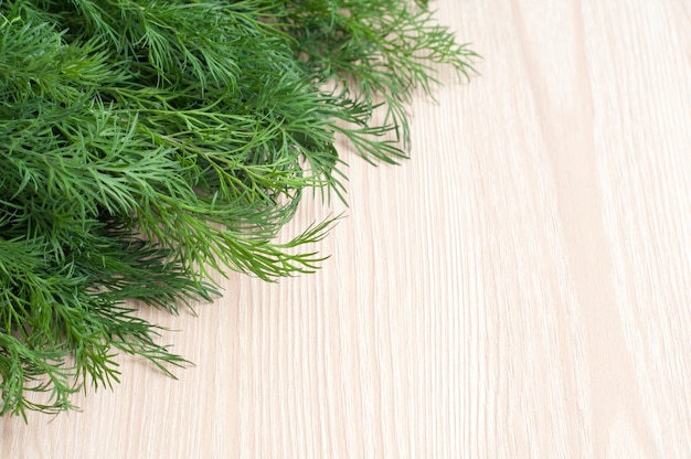 Fresh green dill on wooden table