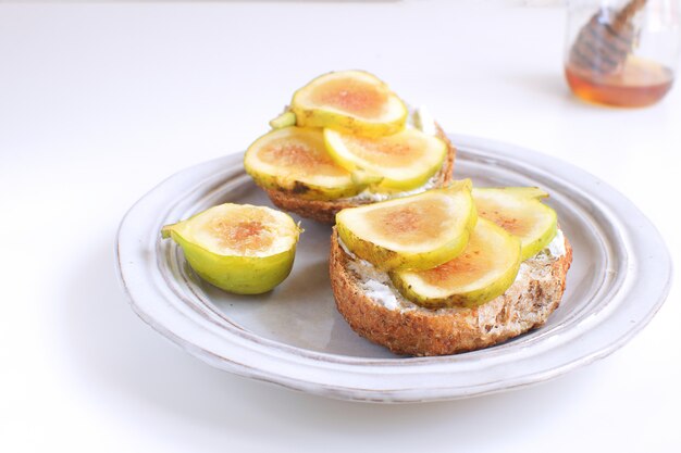 Fresh green figs sandwiches canapes Grey rustic plate Wholegrain bread