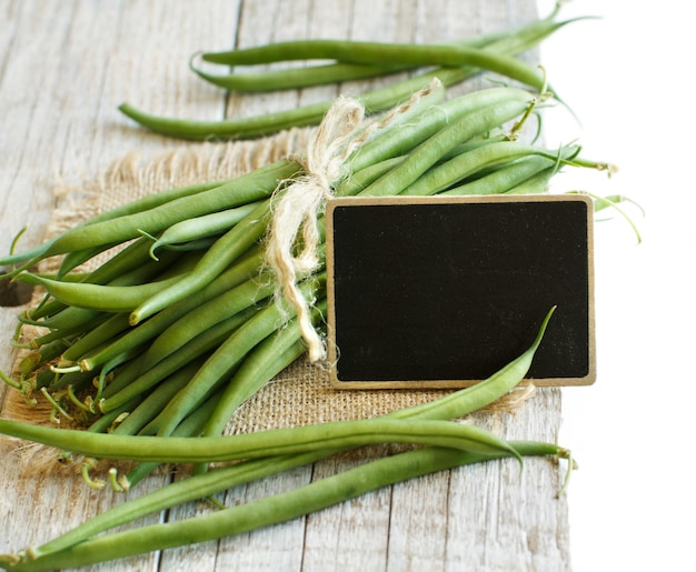 Fresh green french beans on a wood