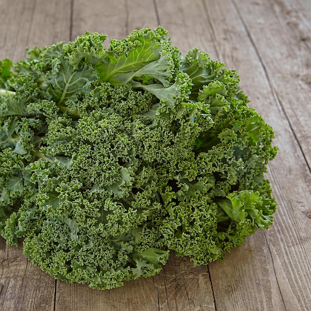 Fresh green kale leaves on wooden table