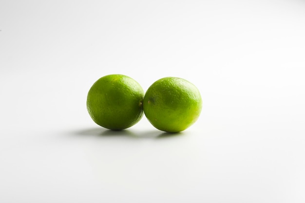 Fresh green lemon on white background