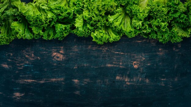 Fresh green lettuce Fresh vegetables On a wooden background Top view Copy space