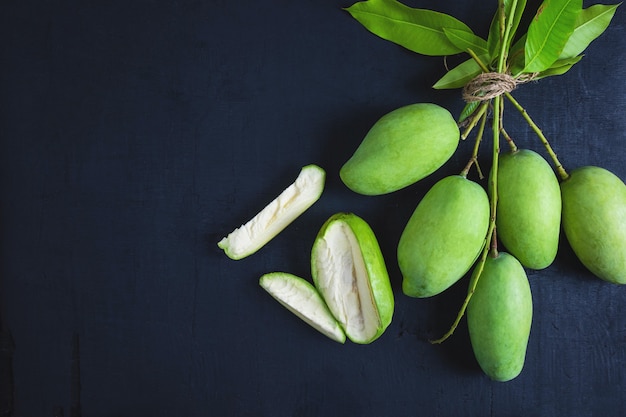 Fresh green mango fruit on a wooden table