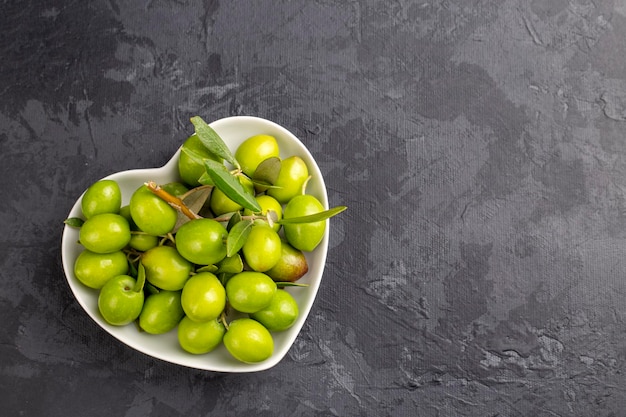 Fresh green olives on the white background