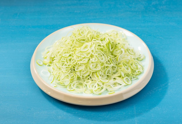 Fresh green onion on blue background