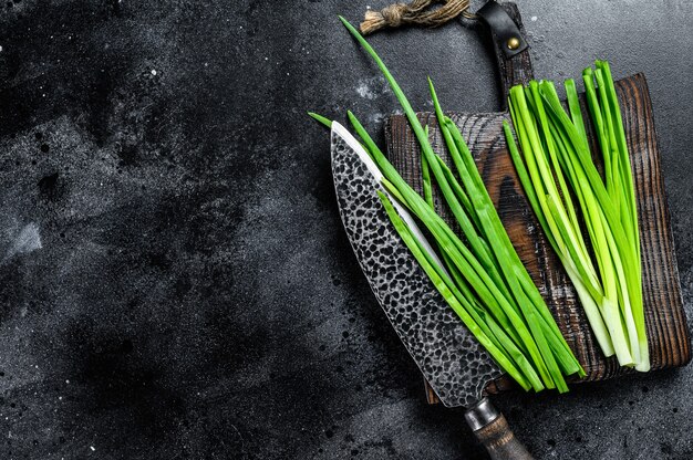 Fresh green onions on a cutting board.