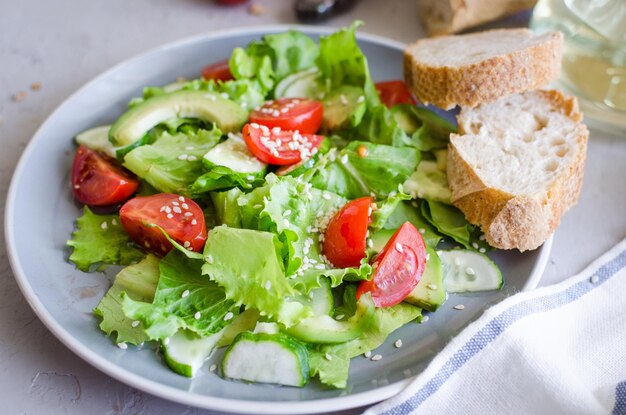 Fresh green organic salad with raw ingredients close up