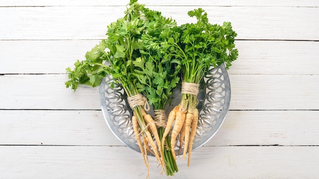 Fresh green parsley Root parsley On a wooden background Top view Copy space