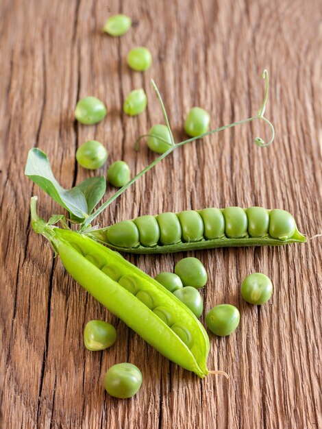 Fresh green pea on wooden table