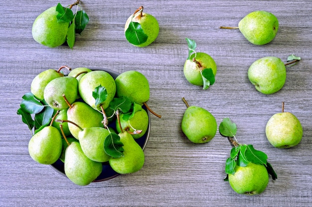 Fresh green pears in a bowl. The harvest of pears.