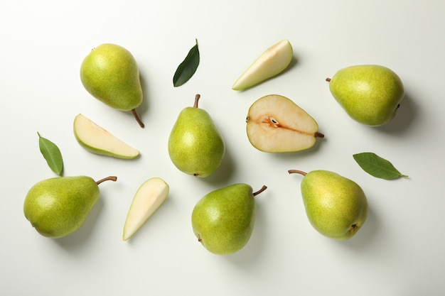 Fresh green pears on white table, top view