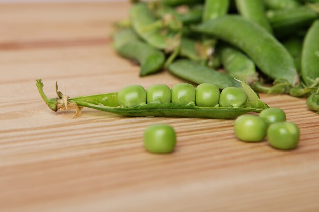 fresh green peas arrangement on wooden table