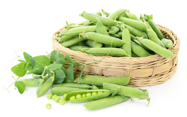 Fresh green peas in basket on white.