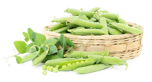 Fresh green peas in basket on a white