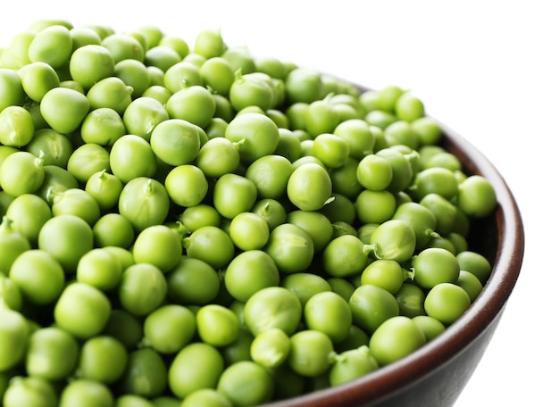 Fresh green peas in bowl close up