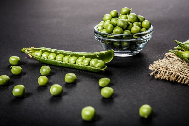 fresh green peas on dark table