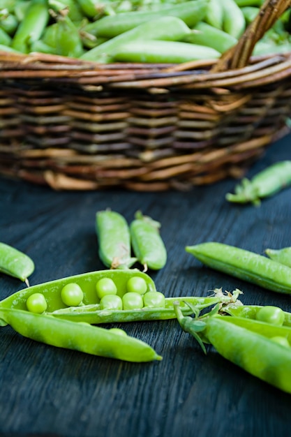 Fresh green peas in a straw basket.