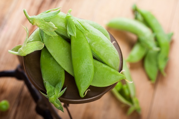 Fresh green peas on vintage scales 