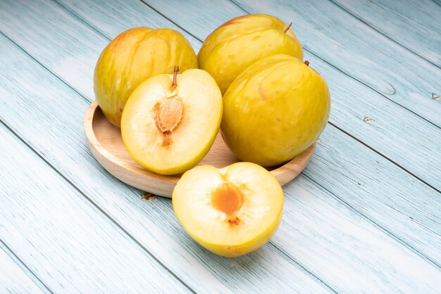 Fresh green plum Granate Plum on wooden background