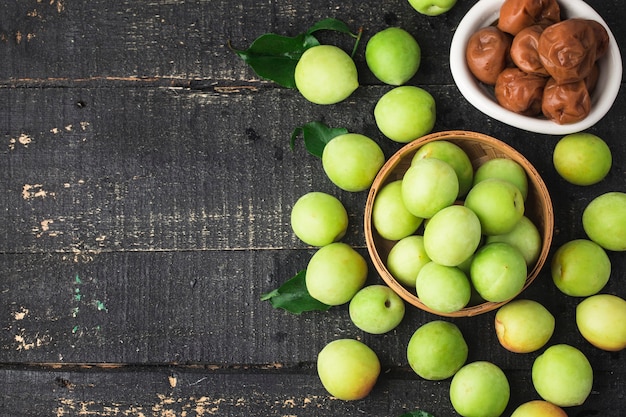 Fresh green plums and preserved green plums