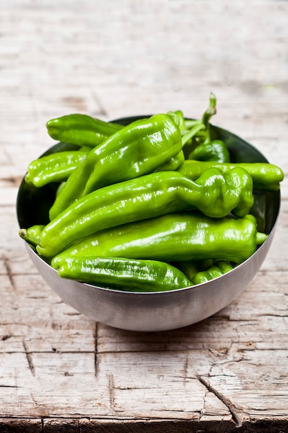 Fresh green raw peppers in metal bowl o