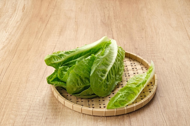 Fresh green romaine lettuce on a wooden background