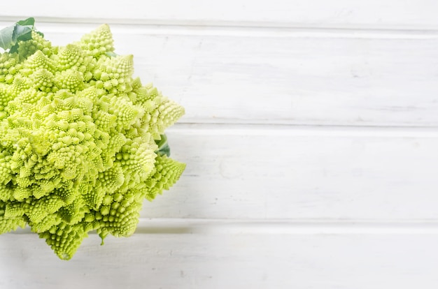 Fresh green romanesco, Raw Organic Cabbage Ready for Cooking on a cutting board