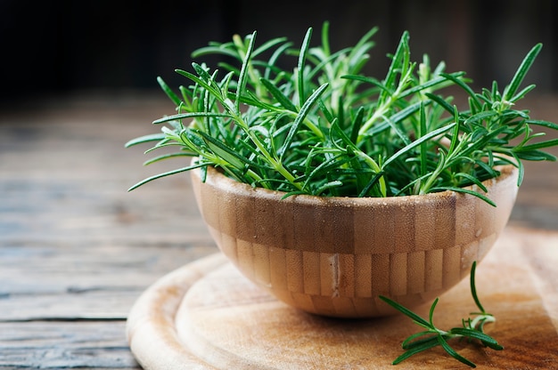 Fresh green rosemary on the wooden table