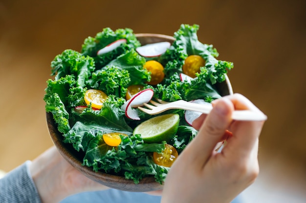 Fresh green salad in a wooden bowl.