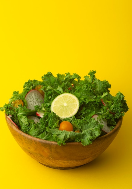Fresh green salad in a wooden bowl.