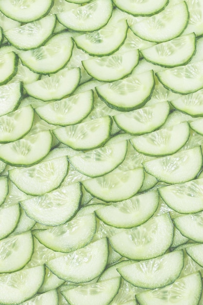 Photo fresh green slices of cucumber as background top view