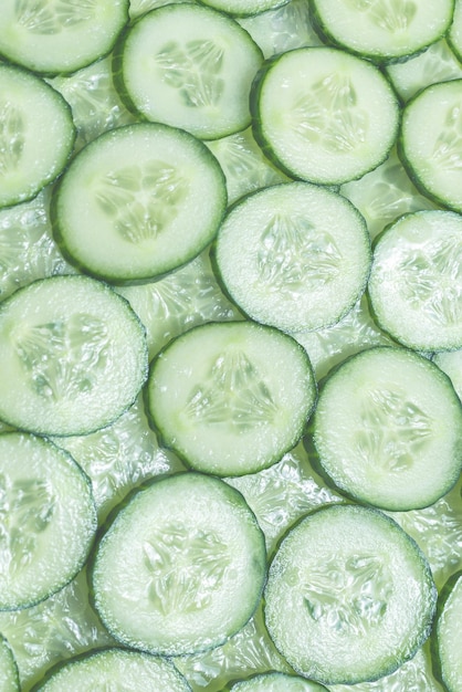 Photo fresh green slices of cucumber as background