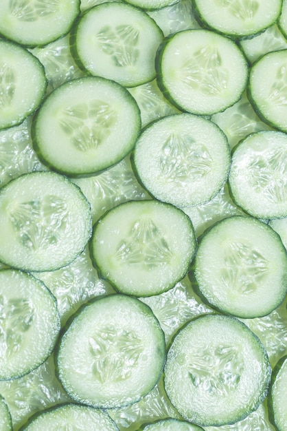 Fresh green slices of cucumber as background