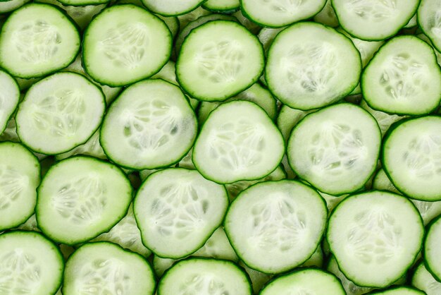 Fresh green slices of cucumber as background