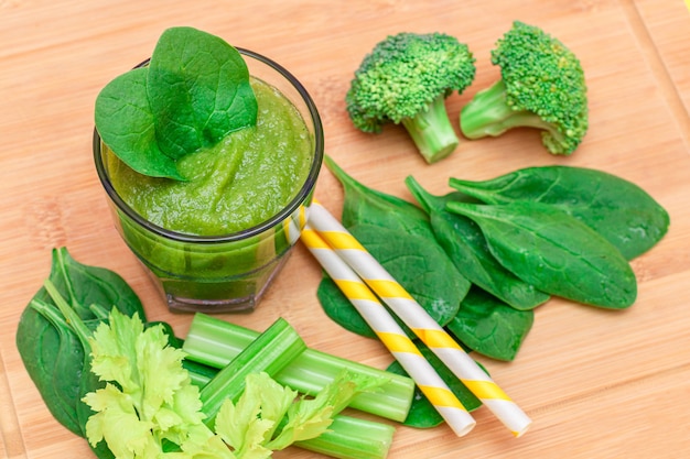 Fresh green smoothie of apple celery and spinach in glass beaker