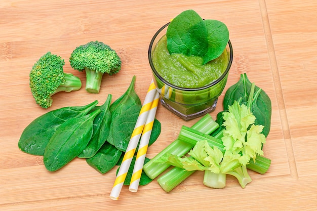 Fresh green smoothie of apple celery and spinach in glass beaker