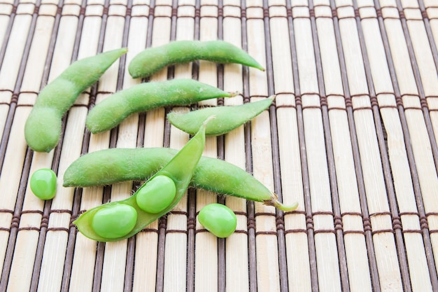 Fresh green soybeans on wooden background