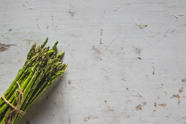 Fresh green spring asparagus on a wooden background. Asparagus season