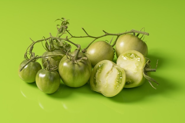 Fresh green tomatoes on a solid background