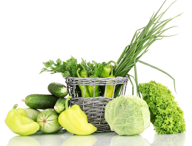 Fresh green vegetables in basket isolated on white