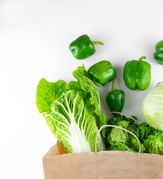 fresh green vegetables from a paper bag
