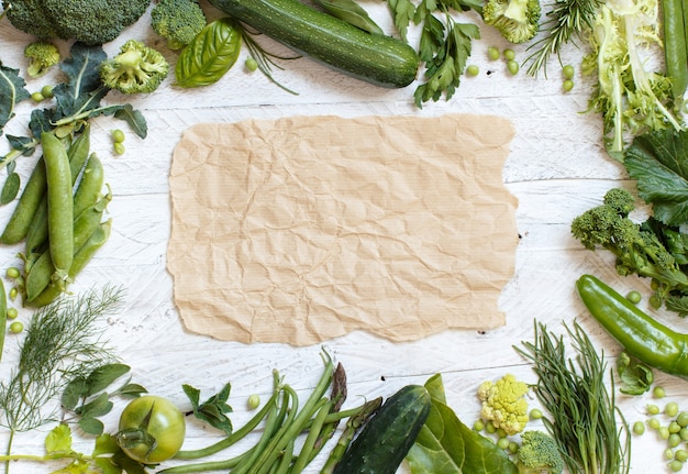 Fresh green vegetables on a wooden table top view