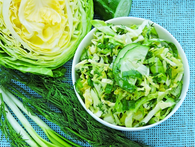 Fresh green vegetarian salad with young cabbage, cucumber and greens