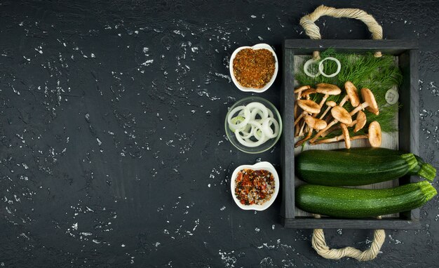 Fresh green zucchini on a dark table. The view from the top. Copy space.