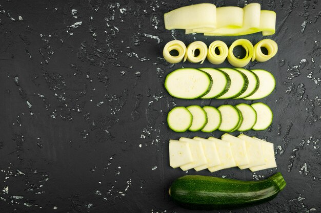 Fresh green zucchini on a dark table