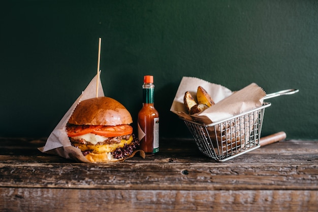 Fresh grilled burger and potato on the table, closeup.