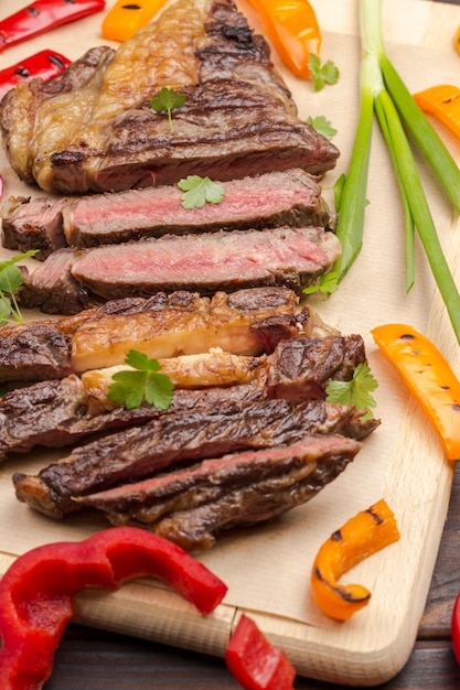 fresh grilled meat. grilled marbled beef steak medium rare on wooden cutting board.â 