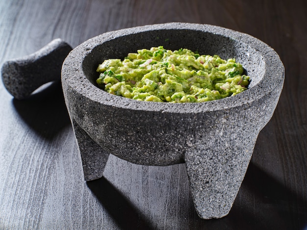 Fresh guacamole in stone molajete