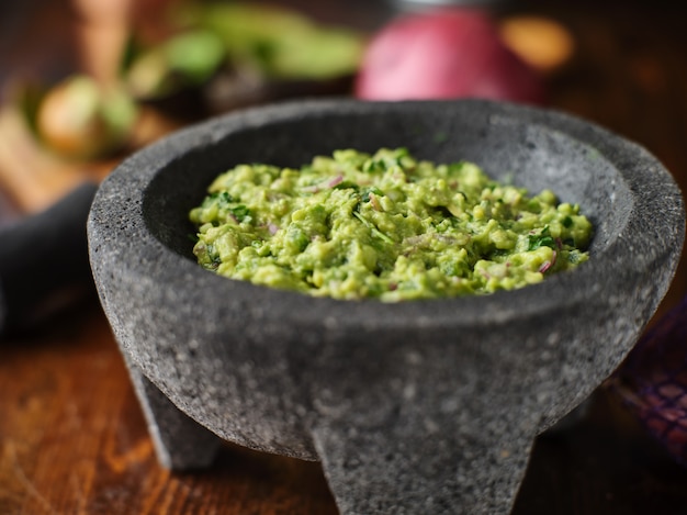 Fresh guacamole in stone molcajete